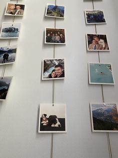 several pictures hanging on a wall with clothes pins attached to them and photos pinned to the wall