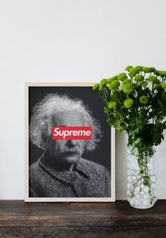 an old photo with the supreme sticker on it next to a vase filled with flowers