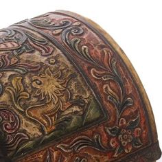 an intricately decorated wooden box with floral designs