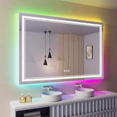 a bathroom with two sinks and a large mirror on the wall above it is lit by colorful lights