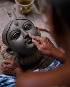 a man is making a mask on top of another person's head with his fingers