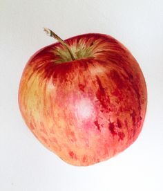 an apple is shown on a white background with watercolors and pencils in it