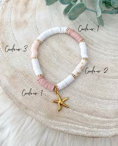 the bracelet with starfish charm is shown on top of a white furnishing