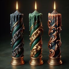 three candles with different colors and designs on them