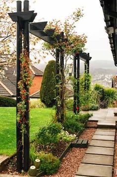 the walkway is lined with plants and trees