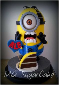 a cake that looks like a minion holding a slice of chocolate cake with the word sale on it