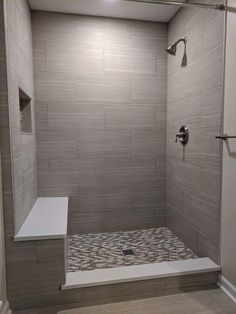 a walk in shower sitting inside of a bathroom