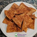 a white plate topped with crackers on top of a table