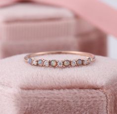 Ethiopian Opal Stacking Ring, Natural Opal Diamond Ring, Australian Opal Stackable Ring Rose Gold, Fire Opal Eternity Band, October Gifts ✧･ﾟ: *✧･ﾟ:* Welcome to Charles Davin Jewelry*:･ﾟ･ﾟ✧ Moissanite - a gemstone known to bring in luck in someone's life, the user can give off a look of elegance. You can give your special someone luck whilst showing your love to them. ✶Material: 10K/ 14K/ 18K ✶Main Stone: Natural Opal; 1.5mm (6pcs) ✶Side Stone: Moissanite Total: 0.05ct ✶Color: D Colorless ✶Clari Stackable Opal Rings, Zug, Opal Stackable Ring, October Gifts, Opal Stacking Ring, Opal Diamond Ring, Stacked Wedding Bands, Sunflower Ring, Opal Band