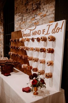 doughnuts are arranged on a display in front of a sign that says donut mind if i do