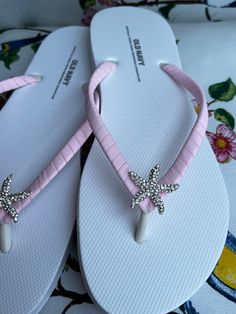 These beautiful flip flops are wrapped in matte light pink ribbon, and adorned with a silver rhinestones starfish button. Ribbon color is pink if you are needing other colors of ribbon or decoration please contact me and will be happy to accommodate you! Please choose from starfish or flower. All flip flops are handmade to order and the production time 1 to 2 weeks and then please allow additional time for shipping. Amazing for beach, weddings, flower girl or a fancy event, you choose! Please choose your size from the drop box. Flip Flops Aesthetic, Pink Wedding Sandals, Shoes For Beach, Light Pink Ribbon, Sandals Party, Fancy Event, Cute Flip Flops, Wedding Flip Flops, Sandals Wedding