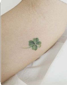 a small four leaf clover tattoo on the ankle