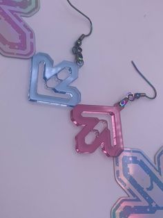 By the players, for the players!  DDR earrings are handmade laser cut pink and blue acrylic.  Two sizes available!  Small is 1.25 inches and larger ones are 1.5 inches.  Hypoallergenic stainless steel hooks  Whether you are a current or former player, these will definitely be fun to wear!  Fact: I wear them to the arcades myself! Just be careful not to get them too sweaty from a session, and definitely handle with care!  Feel free to check out my other rhythm game listings! Rhythm Game Aesthetic, Etsy Dangle Earrings, Gaming Earrings, Gaming Jewelry, Game Earrings, Bisexual Jewelry, Band Earrings, Video Game Jewelry, Character Earrings