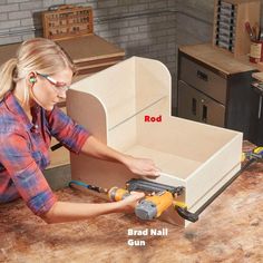 a woman is working on an unfinished cabinet