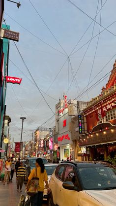 a busy city street with cars and people walking