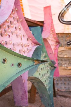 several different colored umbrellas with holes and rivets on them