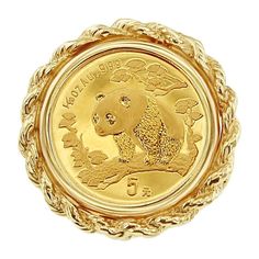 a gold coin with an image of a panda on it