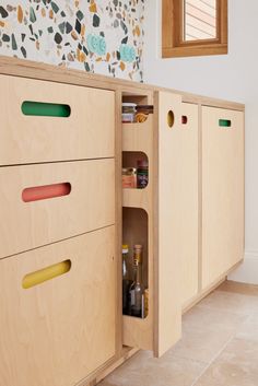 an open cabinet in the middle of a kitchen