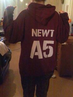 a person wearing a hoodie with the number 55 printed on it