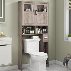 a white toilet sitting next to a wooden cabinet filled with bottles and other bathroom items