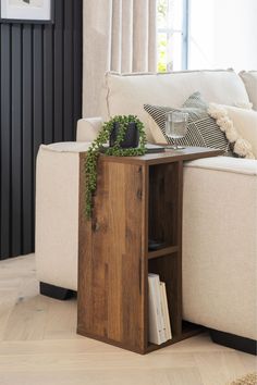 a living room with a white couch and wooden table in it's centerpiece