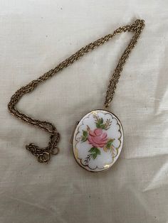 This is a vintage handpainted enamel locket. It is on a 24 inch chain and is in good vintage condition. Measurements of locket are in picture. Vintage Enamel Jewelry With Vintage Charm, Vintage Locket Necklace With Large Pendant For Gift, Oval Enamel Locket Necklace, Oval Locket Necklace In Enamel, Vintage Locket Necklace As Gift, Vintage Hand Painted Round Pendant Necklace, Vintage Keepsake Necklace With Adjustable Chain, Vintage Necklaces With Adjustable Chain For Keepsake, Vintage Hand Painted Pendant Jewelry