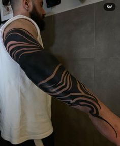 a man with a tattoo on his arm