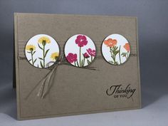 a card with three flowers on it and the words thinking of you written in front