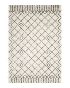 a white and gray rug with diamond shapes on the bottom, along with lines in the middle