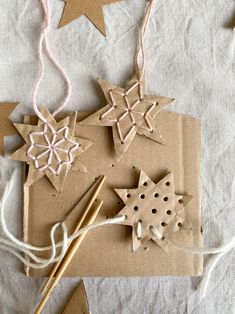 some crafting supplies are laid out on a table with string and star shaped decorations