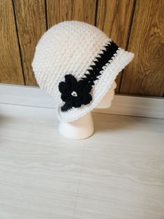 Add a unique and stylish touch to your winter or fall wardrobe with this handmade crochet bucket hat. The hat features a white and black color combination, making it a perfect match for your casual outfits. It is made from high-quality acrylic material and crochet fabric type with beautiful accents that add to its overall charm. This bucket hat is suitable for adults and is perfect for women who love the boho theme. The hat is carefully crafted in the United States, and it is ready to be shipped Adjustable White Crochet Bucket Hat, White Adjustable Crochet Bucket Hat, Casual White Knitted Bucket Hat, White Yarn Bucket Hat With Short Brim, White Brimmed Bucket Hat Made Of Yarn, White Brimmed Yarn Bucket Hat, White Brimmed Bucket Hat In Yarn, White Crochet Bucket Hat, One Size, White Wide Brim Crochet Hat For Winter