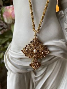 Gorgeous Vintage Designer Baroque inspired European Large Cross and Rope Necklace, antiqued gold tone. This is a beautiful and substantial high quality piece of jewelry that will add a timeless and elegant touch to your wardrobe.   The rope necklace is heavy and it measures 30.5 inches long. The Cross is embellished with mocha, beige and clear crystals and a faux pearl and it measures 2.25inches  tall x 1.80 inches Wide. The necklace with the cross pendant measure  a bit over 33" long. Vintage e Luxury Elegant Crucifix Cross Necklace, Gold Baroque, Long Rope, Gold Cross Necklace, Baroque Fashion, Rope Necklace, Clear Crystals, Gold Cross, Vintage Designer