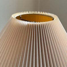 a lamp shade that is made out of pleated paper