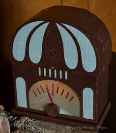 an old fashioned clock sitting on top of a table