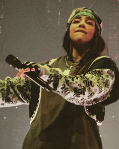 a woman holding a tennis racquet on top of a stage