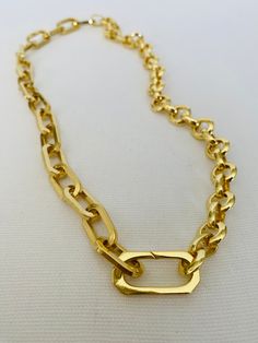 This versatile necklace offers three different looks in one stunning piece of jewelry. Crafted with a combination of two gold chains, including a gold paper clip chain and round rolo chain, it is finished with a connector clasps. The necklace measures approximately 17 inches in length and can be rotated to achieve three distinct styles. In the first look, you can showcase the bold statement necklace by wearing it with the gold paper clip chain prominently displayed. The unique and contemporary d Modern Gold Necklace With Paperclip Chain, Oval Link Cable Chain Necklace For Layering, Gold Toggle Necklace With Paperclip Chain, Chic Gold Toggle Necklace With Paperclip Chain, Gold Chic Toggle Necklace With Paperclip Chain, Gold Double Chain Link Necklace, Formal Toggle Necklace With Chunky Link Chain, Modern Gold-tone Chain Necklace With Rectangular Links, Gold Link Chain Necklace With Double Chain