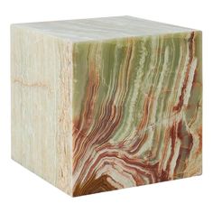 a green and brown marble block sitting on top of a white floor