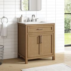 a bathroom with a sink, mirror and towel rack