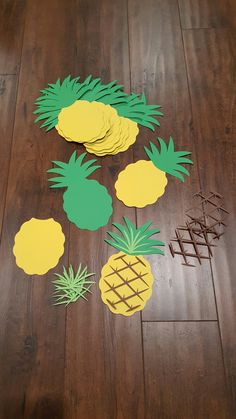 pineapple cut out on the floor next to some sticks