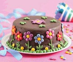 a chocolate cake decorated with flowers on a plate