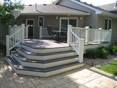 an outdoor patio with steps leading up to the house