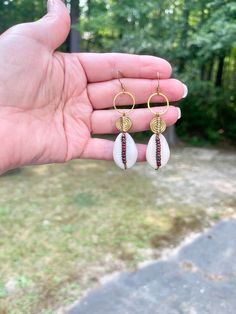 These cowrie shell beaded earrings are gorgeous. They look good with any outfit. They are one of kind and unique.  They are delicately designed with cowrie shells, brass spiral beads, and accented with red miyuki Picasso beads, with brass french hook ear posts These earrings come to you in a white box ready for gift giving Please note colors may vary from picture, and it is advised to not wear in water or get wet. Your satisfaction is my first priority. If you are not happy with your purchase fo Handmade Seashell Jewelry, Bohemian Shell Jewelry For Pierced Ears, Bohemian Shell Earrings Nickel Free, Nickel Free Shell Bohemian Earrings, Bohemian Nickel-free Shell Earrings, Bohemian Shell Earrings For Jewelry Making, Bohemian Shell Dangle Earrings, Bohemian Dangle Shell Earrings, Handmade Bohemian Shell Earrings