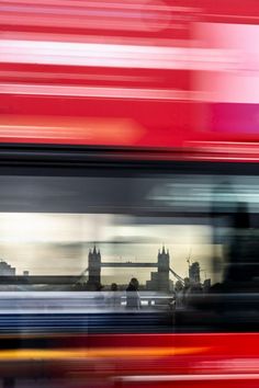 a blurry photo of the london skyline with tower bridge in the background, taken from a moving bus