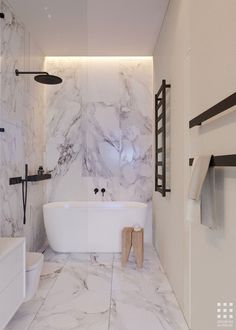 a bathroom with marble walls and flooring in white, black and grey colors is shown