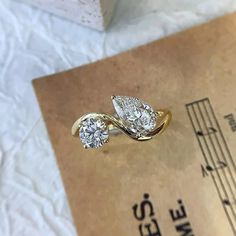 two diamond rings sitting on top of a piece of paper