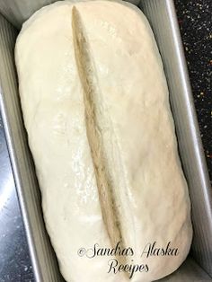 a loaf of bread sitting in a pan on top of a counter