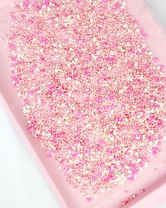 pink and white sprinkles in a tray