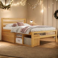 a bed sitting on top of a wooden floor next to a wall filled with lights