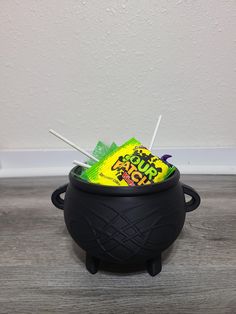 a black caulder with candy sticks sticking out of it