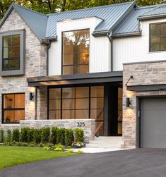 a large house with two garages in the front and one on the other side